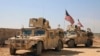 This March 7, 2017, frame grab from video provided by Arab 24 network, shows U.S. forces take up positions on the outskirts of the Syrian town, Manbij, a flashpoint between Turkish troops and allied Syrian fighters and U.S.-backed Kurdish fighters, in al-Asaliyah village, Aleppo province, Syria.