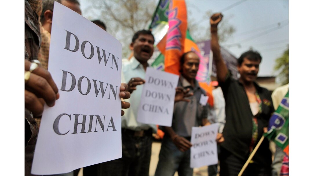 Indian activists shout slogans and hold placards during a protest in Guahati, India, Wednesday, March 21, 2012. The activists were protesting against the construction of dams in China in the middle reaches of the Brahmaputra River, or the Yarlung…