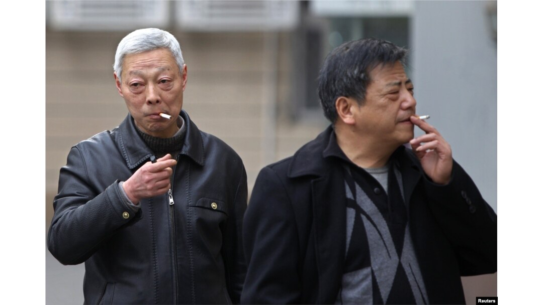 FILE - Smokers are seen on a street in Shanghai, China, March 22, 2012.