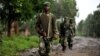 M23 rebel group soldiers patrol in Rangira, near Rutshuru, DRC, October 17, 2012.