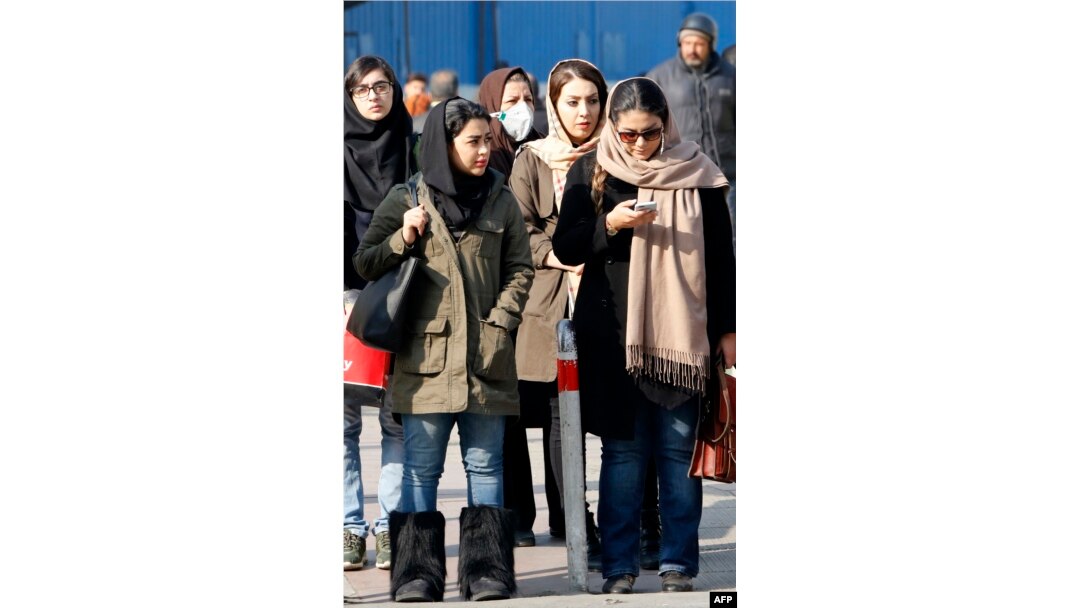 Iranian women wearing hijab walk down a street in the capital Tehran, Feb. 7, 2018. A spate of protests against Iran's mandatory headscarves for women have been few but have reignited a debate that has preoccupied the Islamic republic since its founding.