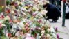 People place flower tributes at the synagogue in Copenhagen, Denmark, Feb. 16, 2015.