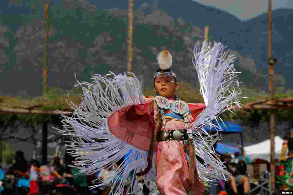 Seven-year-old Kelly Dee, who is Navajo Hopi, competes in junior girls' fancy shawl category on the second day of the 32nd Annual Taos Pueblo Pow Wow, a Native American dance competition and social gathering, in Taos, New Mexico, July 8, 2017.