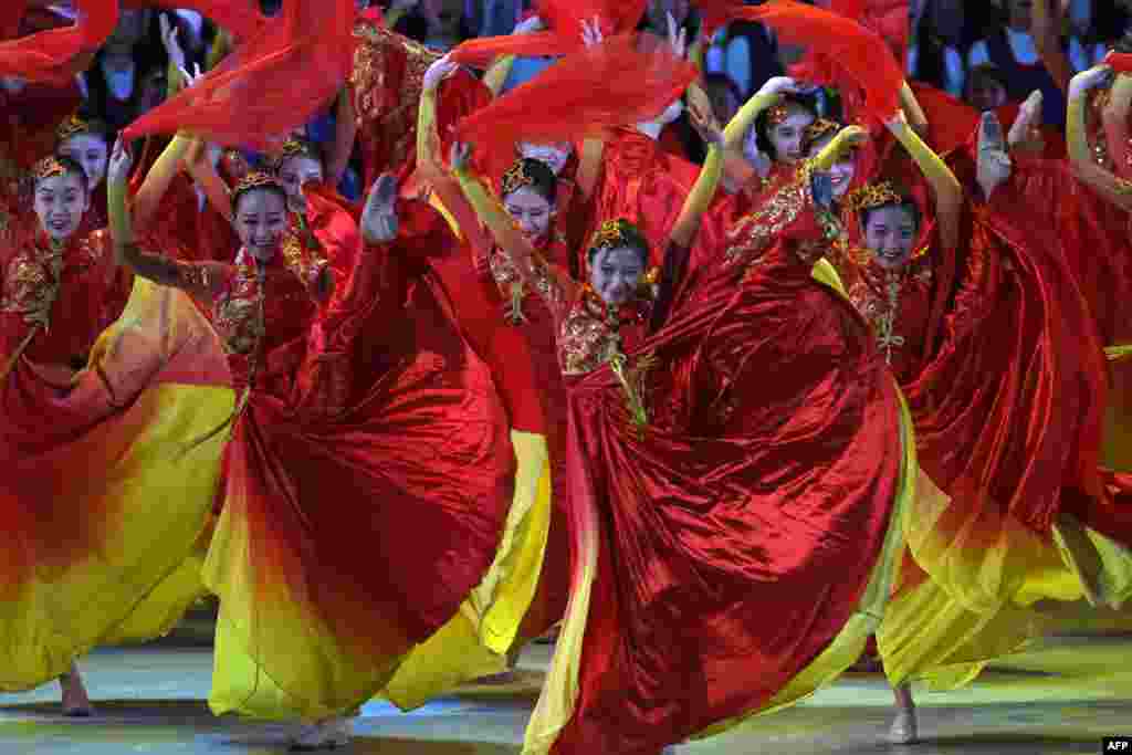 Performers dance during a variety show attended by China's President Xi Jinping in Hong Kong. China's President Xi Jinping praised Hong Kong for its role in China's economic development as he addressed a banquet, which included lawmakers and business figures.
