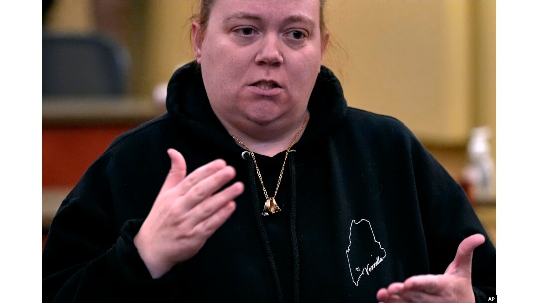 Megan Vozzella, who is deaf, signs while describing concerns following a visit by Steven Dettelbach, director of the ATF, at Central Maine Community College on Feb. 22, 2024, in Auburn, Maine. Vozzella's husband was killed in the October 2023 mass shootings in Lewiston, Maine.