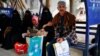 FILE - Ashjan Muhammad al-Qamis, 30, waits with her father at a hospital where she receives cancer treatment in Sanaa, Yemen, Aug. 16, 2021.