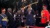 Kenya's President Uhuru Kenyatta (C) displays the special sword that he received to represent his instruments of power and authority from his predecessor, Mwai Kibaki (2nd L), after his official swearing-in ceremony at Kasarani Stadium in the capital Nair