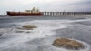 FILE - An abandoned ship is stuck in solidified salt at Lake Urmia, northwestern Iran. Once one of the biggest saltwater lakes on Earth, Urmia has been decimated by climate change, irrigation use and damming of nearby rivers.