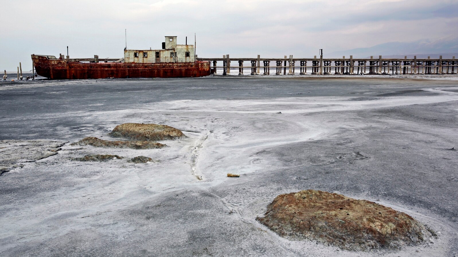 FILE - An abandoned ship is stuck in solidified salt at Lake Urmia, northwestern Iran. Once one of the biggest saltwater lakes on Earth, Urmia has been decimated by climate change, irrigation use and damming of nearby rivers.