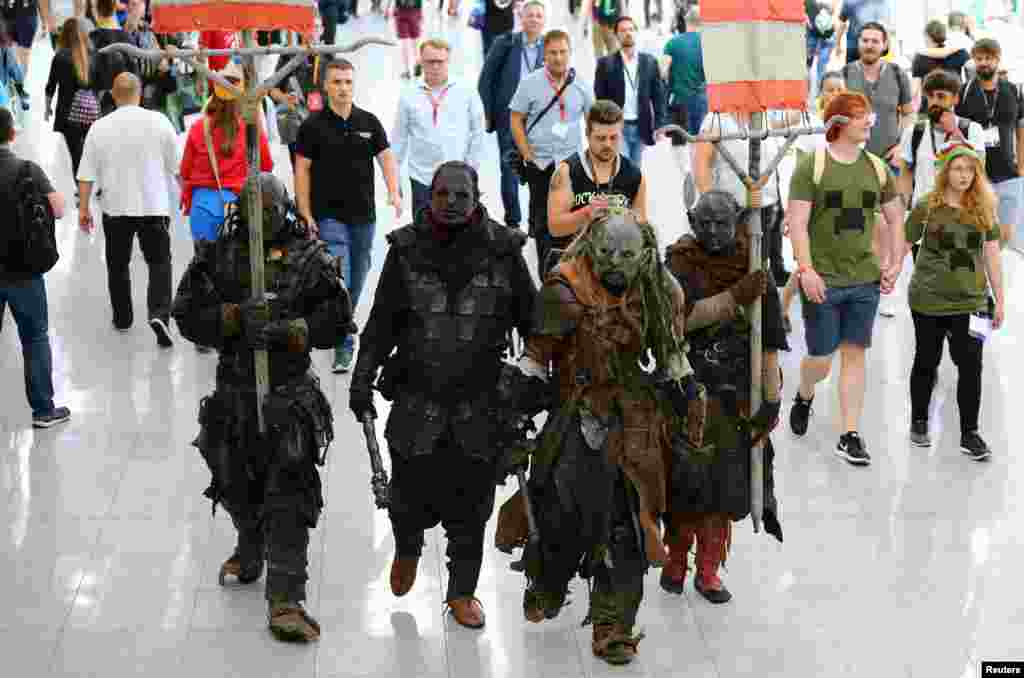 People dressed up as Middle-earth: Shadow of War game characters are seen during the world's largest computer games fair Gamescom in Cologne, Germany.