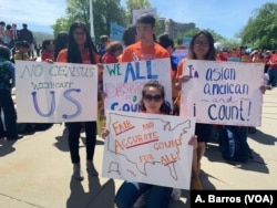 Protesters are seen in front of the U.S. Supreme Court in Washington as justices hear arguments on a citizenship question the Trump administration wants to add to the census questionnaire, April 23, 2019.