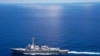 FILE - USS Lassen (DDG 82) operates in international waters near the Chinese People's Liberation Army (Navy) Jianghu V-class frigate Dongguan (560) while on patrol in U.S. 7th Fleet at South China Sea, Sep 29, 2015.