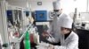 FILE - Workers of the Ryongaksan Soap Factory make disinfectants in Pyongyang, North Korea, March 19, 2020. A report cities North Korea as the country with the largest burden of work-related deaths.