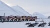 Snow scooters are seen parked in the town of Longyearbyen in Svalbard, March 26, 2012. 