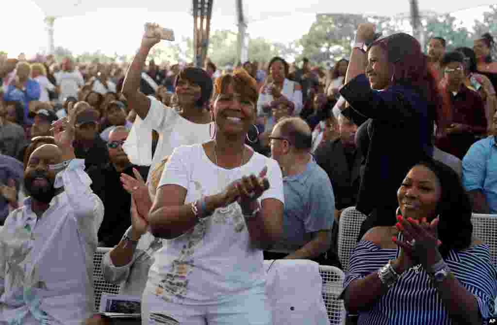 Fans clap and dance as they attend a tribute concert to Aretha Franklin at Chene Park, Aug. 30, 2018, in Detroit.
