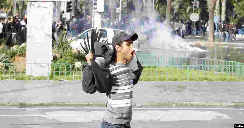 A protester gestures to police during clashes in Tunis, Feb. 6, 2013.