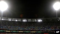 FILE - In this March 8, 2020, photo, fans nearly fill the Melbourne Cricket Ground during the Women's T20 World Cup cricket final match between Australia and India in Melbourne, Australia.
