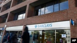Pedestrians pass a branch of Barclays Bank in Swiss Cottage in London, Sept. 20, 2013.