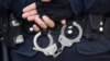 FILE - A Turkish riot police officer's handcuffs are pictured at the entrance of a courthouse in Istanbul. Human Rights Watch is calling for "urgent and effective investigation of the abduction and possible enforced disappearances of at least four men in Ankara since March 2017."
