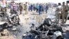 Iraqi army personnel and people gather at the site of a car bomb attack in the city of Kut, southeast of Baghdad, July 29, 2013. 