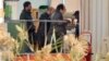 An unidentified person right, is followed by Algerian officials as they enter a morgue in Ain Amenas Algeria Monday, Jan. 21, 2013, where the bodies of the persons killed during the hostage situation at the gas plant in Ain Amenas,. At least 81 people ha