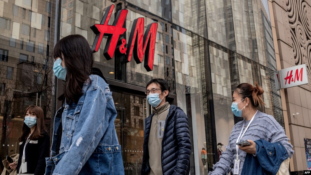 People walk past a store of Swedish clothing giant H&M in Beijing on March 25, 2021.