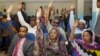 Somalia lawmakers raise their hands during a confidence vote on Prime Minister Abdiweli Sheikh Ahmed, at the Parliament Building in Mogadishu, Somalia, Dec. 6, 2014.