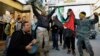 Palestinians dance after hearing that Ariel Sharon, the hard-charging Israeli general and prime minister, died, as they celebrate in the Ein el-Hilweh camp near the southern city of Sidon, Lebanon, Jan. 11, 2014