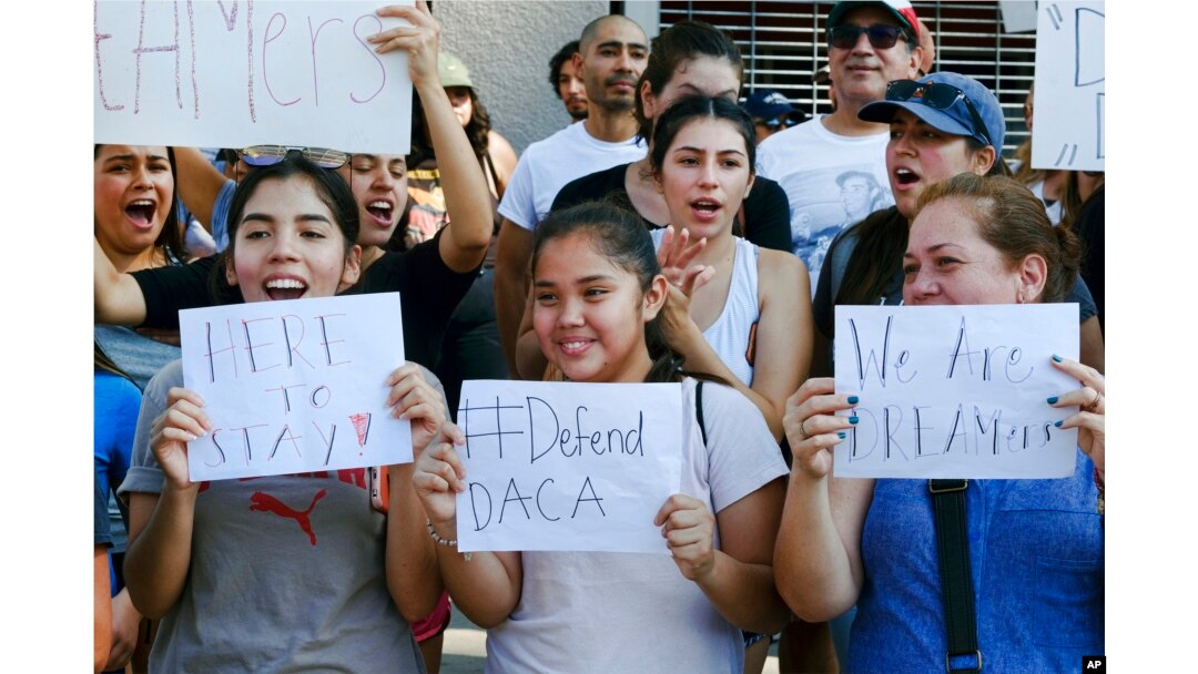 Supporters of the Deferred Action for Childhood Arrivals, or DACA, chant slogans and holds signs while joining a Labor Day rally in downtown Los Angeles on Sept. 4, 2017.