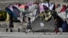 FILE - Internally displaced Afghan children play at the Saray Shamali IDP camp in Kabul, Afghanistan, Nov. 2, 2021. An aid agency said Tuesday that Afghanistan's Taliban authorities evicted about 1,700 people from a makeshift settlement in Kabul and demolished it.