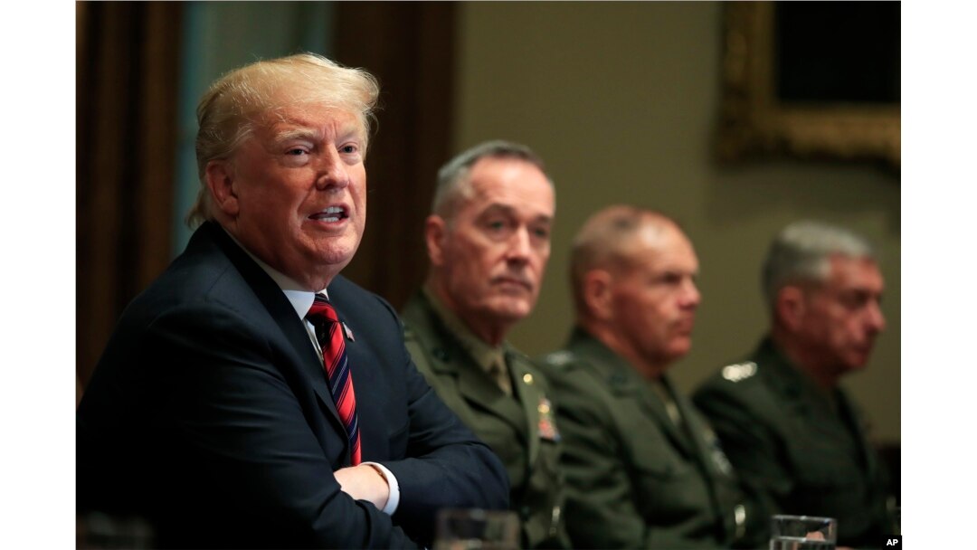 President Donald Trump, with Joint Chiefs Chairman Gen. Joseph Dunford and Marine Corps Commandant Gen. Robert Neller, speaks during a briefing with senior military leaders in the Cabinet Room at the White House in Washington, Oct. 23, 2018.