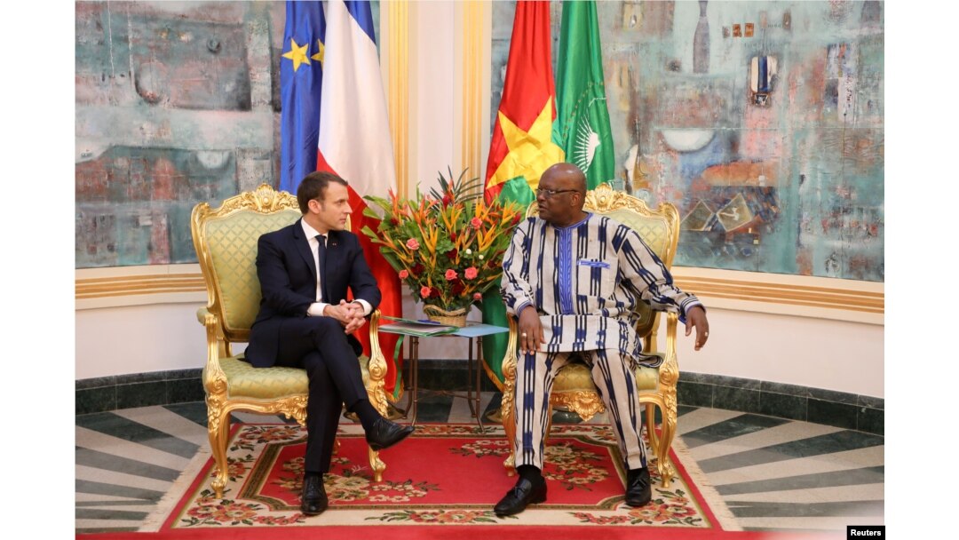 FILE - French President Emmanuel Macron attends a meeting with Burkina Faso's President Roch Marc Christian Kabore at the Presidential Palace in Ouagadougou, Burkina Faso, Nov. 28, 2017.