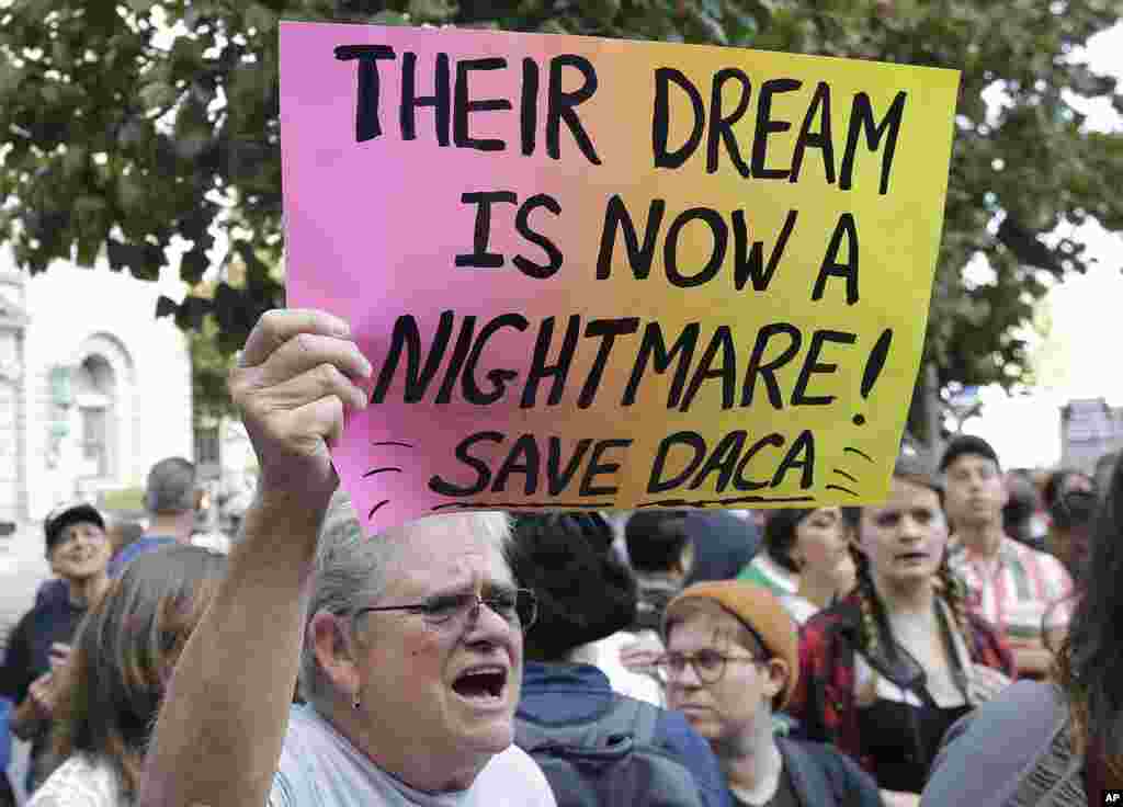 Judy Weatherly, a supporter of the Deferred Action for Childhood Arrivals (DACA), holds up a sign during a protest outside of the Federal Building in San Francisco, California, Sept. 5, 2017. President Donald Trump began dismantling DACA, the government program protecting hundreds of thousands of young immigrants who were brought into the country illegally as children.