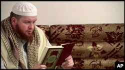 FILE - This image provided by New Zealand 3 News/MediaWorks via APTN shows Mark Taylor, who converted to Islam and is now thought to be in Syria, as he reads the Quran in his native New Zealand.