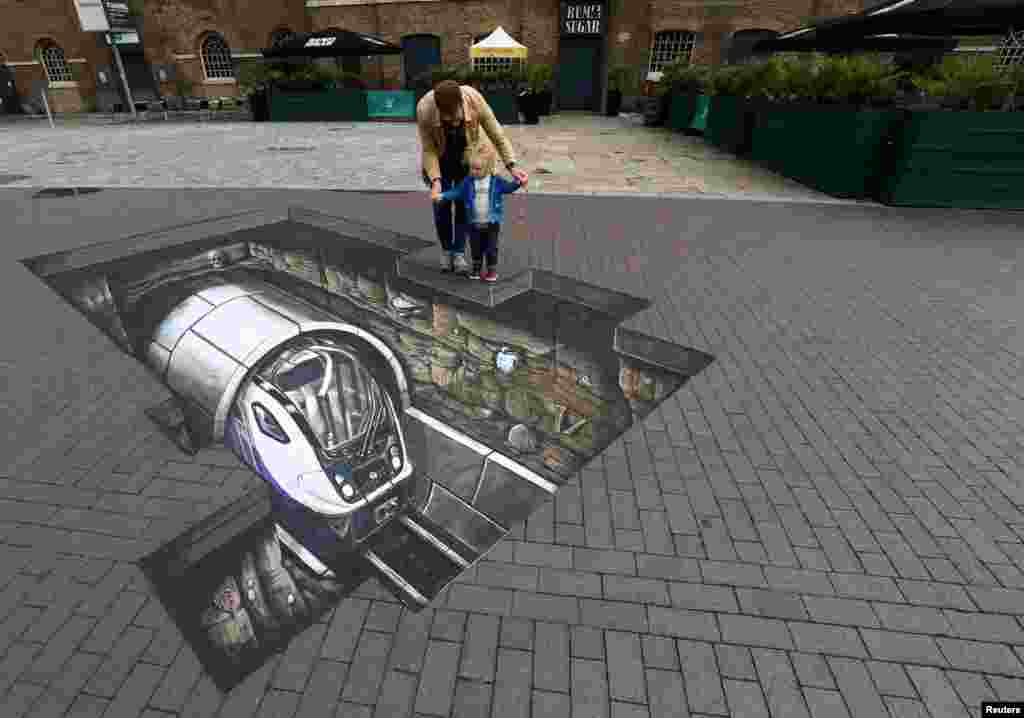 Mike Clueless and son Elliot pose by a piece of Crossrail-themed 3D artwork at the Museum of London.
