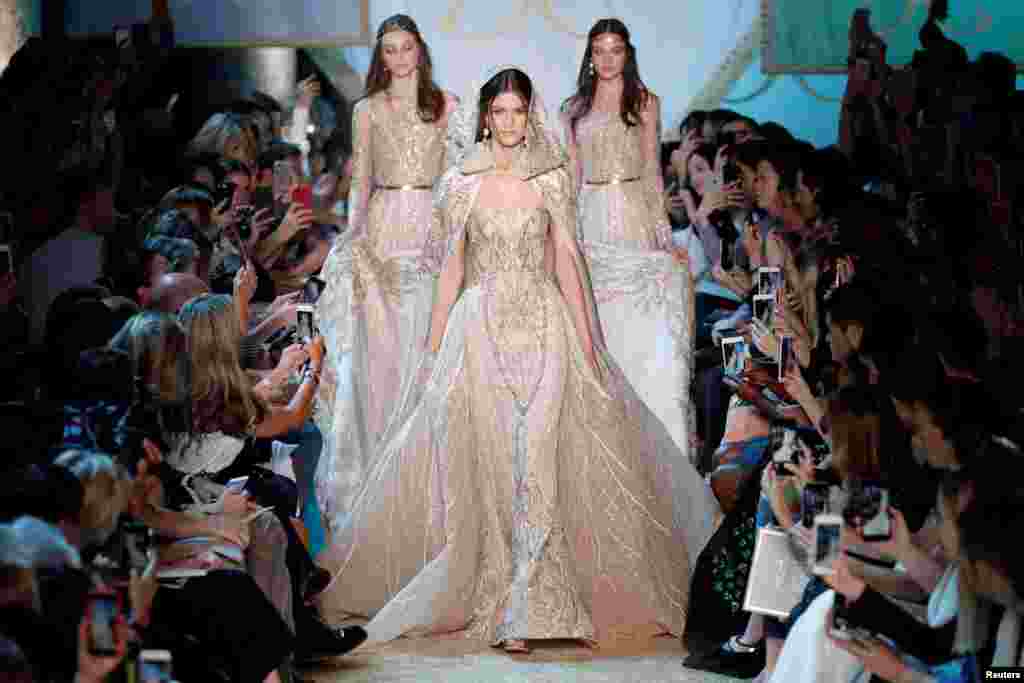 A model presents a wedding dress creation by Lebanese designer Elie Saab as part of his Haute Couture Fall/Winter 2017/2018 collection show in Paris, France.