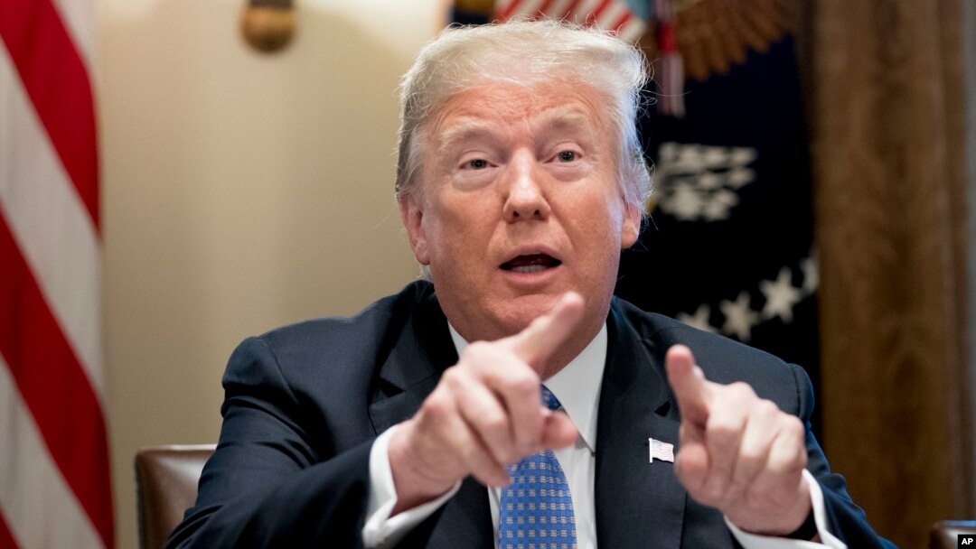 FILE - President Donald Trump points to members of the media as he speaks during a meeting in the Cabinet Room of the White House in Washington, Aug. 1, 2018.