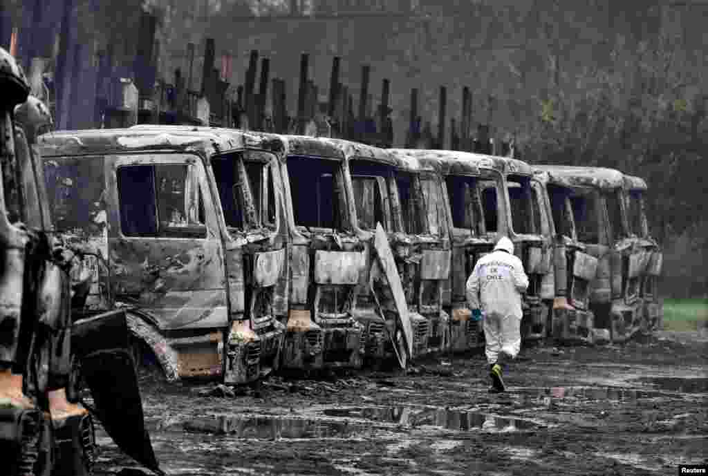 Burnt-out trucks are seen in the San Jose de La Mariquina commune, south of Santiago, Chile.