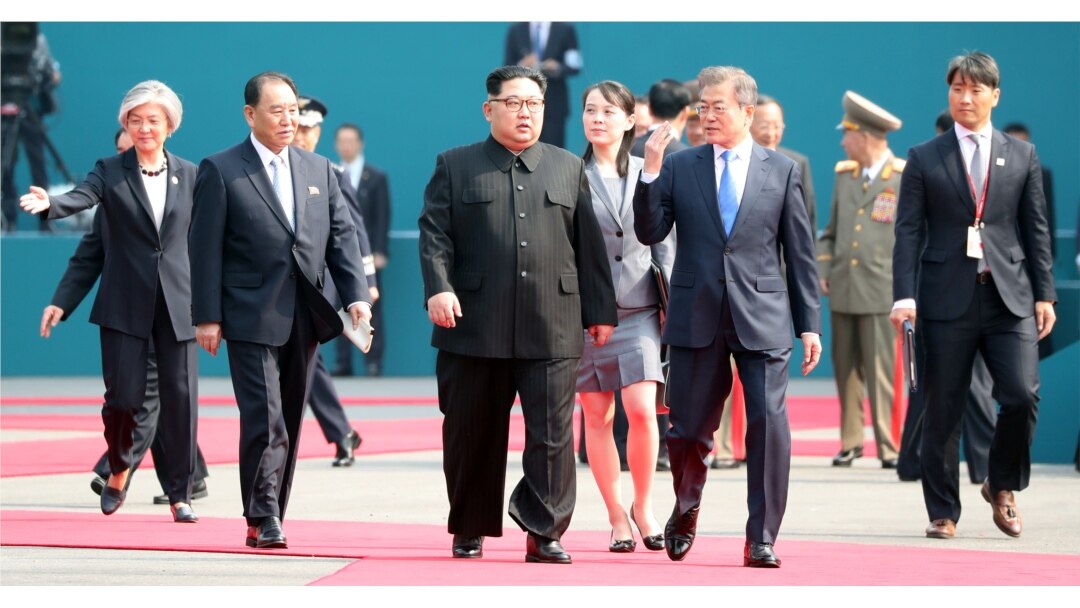 FILE - South Korean President Moon Jae-in and North Korean leader Kim Jong Un arrive at the Peace House in the truce village of Panmunjom inside the demilitarized zone separating the two Koreas, South Korea, April 27, 2018.