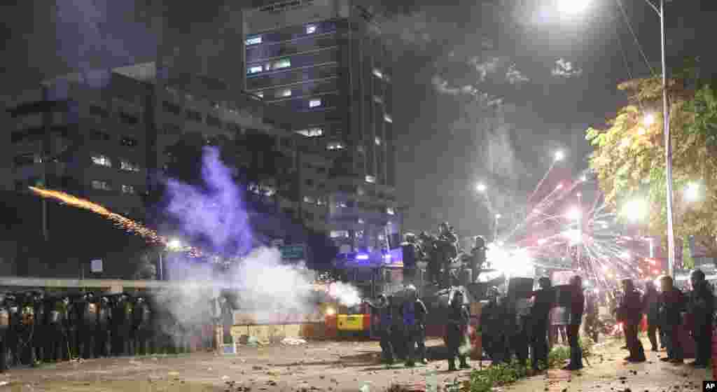 Riot police fire tear gas to disperse students protesting a new law that they said has crippled the country's anti-corruption agency, during a clash outside parliament in Jakarta, Indonesia.