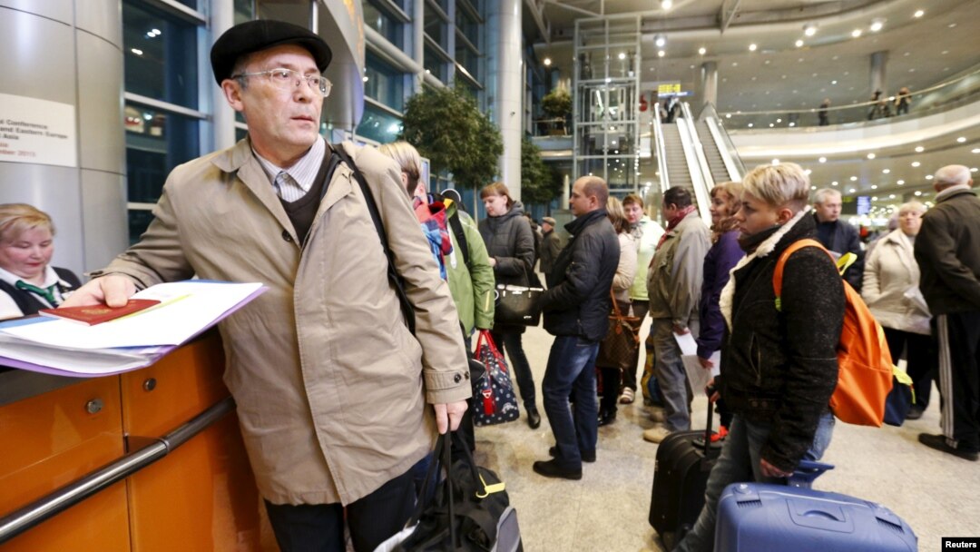 Passengers, whose flights to Egypt were suspended, gather at an information desk of Domodedovo airport outside Moscow, Russia, Nov. 6, 2015.