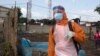 FILE - A health worker prepares to disinfect a van used for burial purposes in Freetown, Sierra Leone.