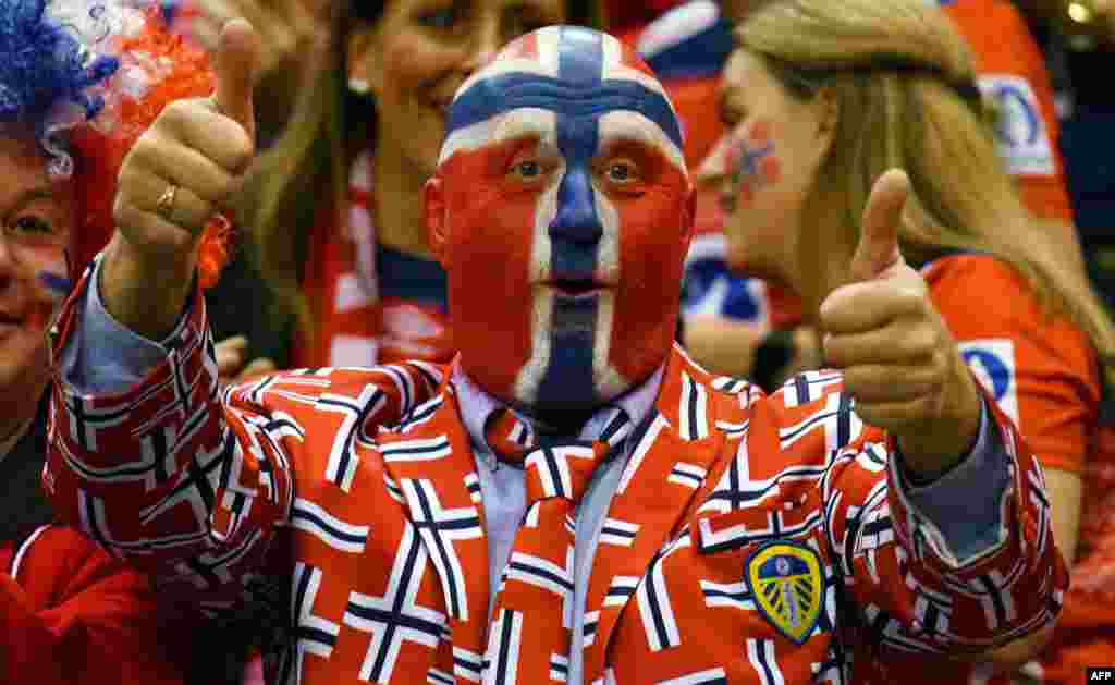 A supporter of Norway cheers up his team during the IHF Women’s World Championship handball final match between France and Norway in Hamburg, nothern Germany.