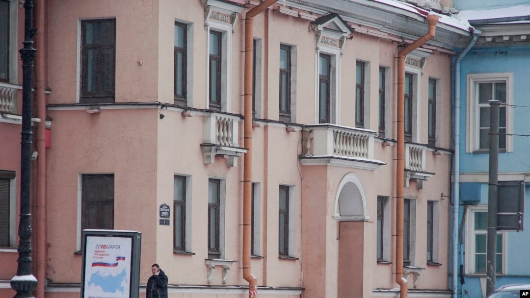 FILE - In this photo taken on Feb. 18, 2018, a security guard walks outside the Concord Catering office in St. Petersburg, Russia.