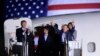 President Donald Trump, from left, greets Tony Kim, Kim Hak Song, seen in the shadow, and Kim Dong Chul, three Americans detained in North Korea for more than a year, as they arrive at Andrews Air Force Base in Md., May 10, 2018. First lady Melania Trump also greets them at right. 