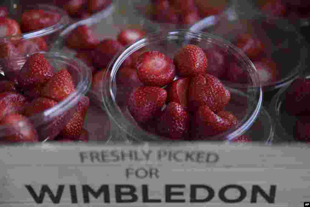 Strawberries for sale on display, on day five at the Wimbledon Tennis Championships in London. Green grass, tennis whites and big red strawberries. It can only be Wimbledon - even though nobody really seems to know how the seasonal fruit became ubiquitous at the All England Club.