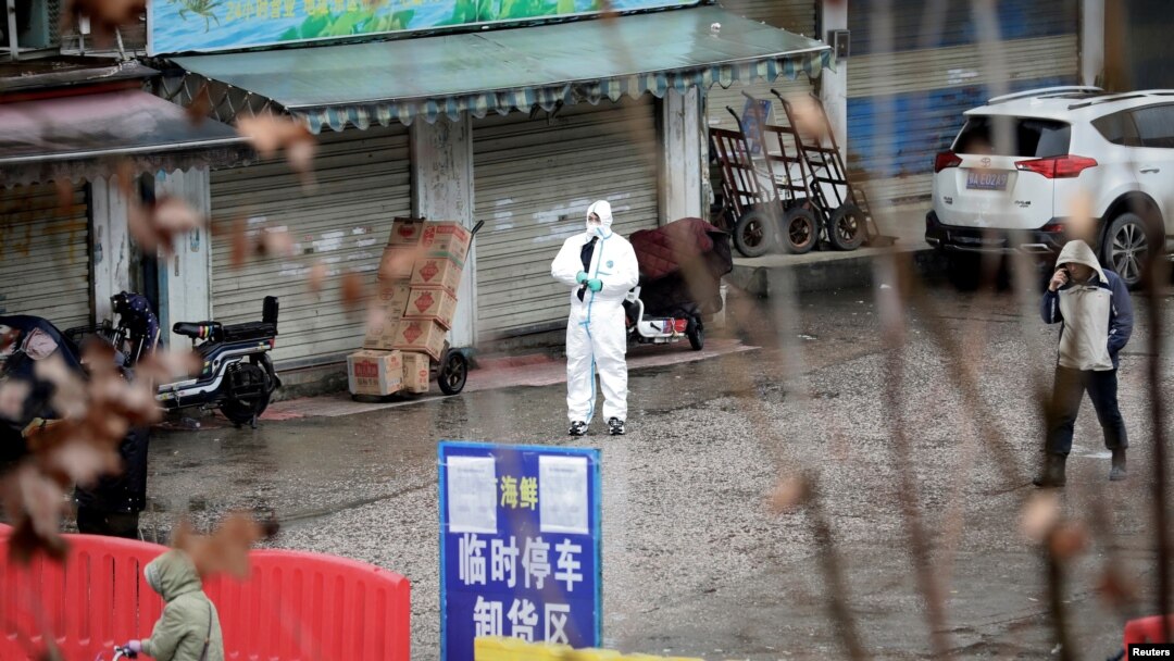 A worker in a protective suit is seen at the closed seafood market in Wuhan, Hubei province, China, Jan. 10, 2020. 