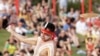 FILE - An Aboriginal man swings an instrument known as a bullroarer during the Wugulora Indigenous Morning Ceremony as part of Australia Day celebrations in Sydney, Australia, Jan. 26, 2020.