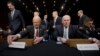 FILE - Director of National Intelligence James Clapper (L) and CIA Director John Brennan (R) take their seats to testify before the Senate Intelligence Committee hearing on current and projected national security threats against the US, on Capitol Hill in Washington, Jan. 29, 2014. Also taking their seats on the panel are Defense Intelligence Agency Director Lt. Gen. Michael Flynn (R) and FBI Director James Comey (L).