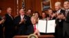 U.S. President Donald Trump holds up a signed Antiquities Executive Order during a ceremony at the Interior Department in Washington, April, 26, 2017. 